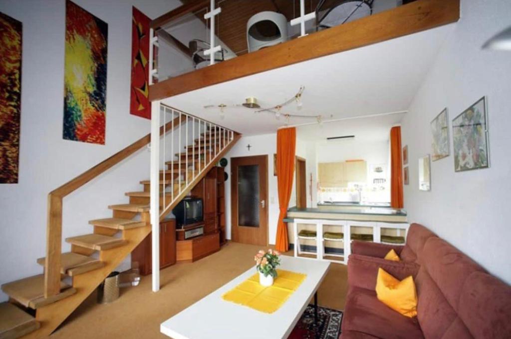 a living room with a couch and a staircase at Haus Lucia in Schönwald