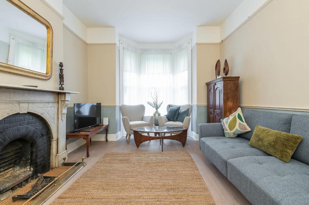 a living room with a couch and a fireplace at Oakwood House in Dublin