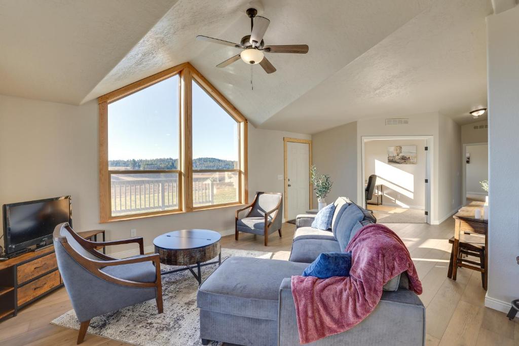 a living room with a couch and a tv at Peaceful Deary Vacation Rental with Deck and Views! 