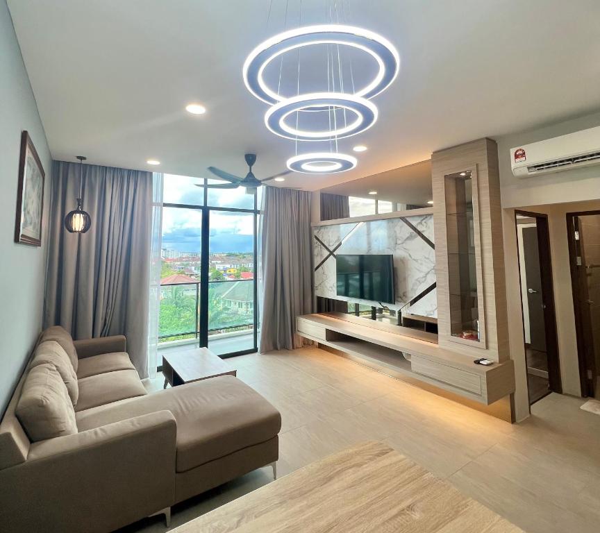 a living room with a couch and a large window at Rex-apartment 3room near new Kpj Saradise Bdc in Kuching
