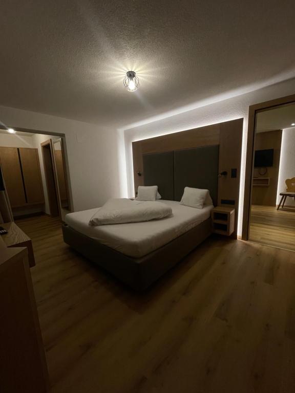 a bedroom with a bed and a light on the ceiling at Dependance Central in Ischgl