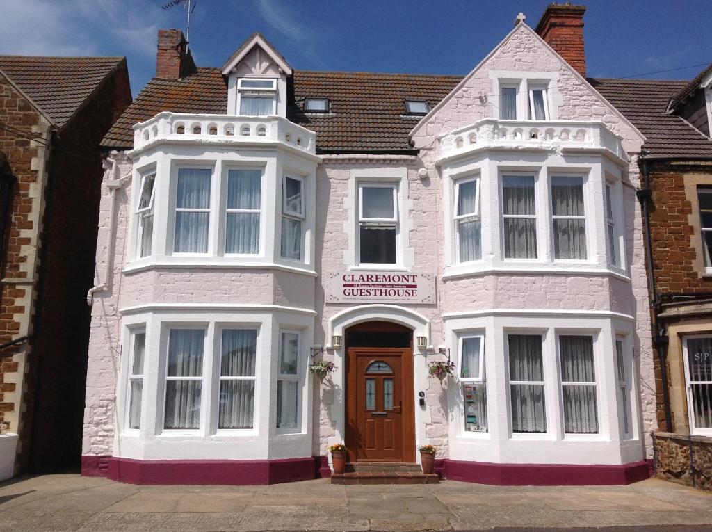 a large white building with a brown door at Claremont Guesthouse in Hunstanton