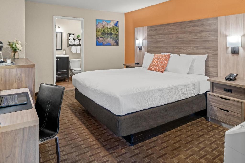 a hotel room with a bed and a desk at Buck Meadows Lodge in Groveland