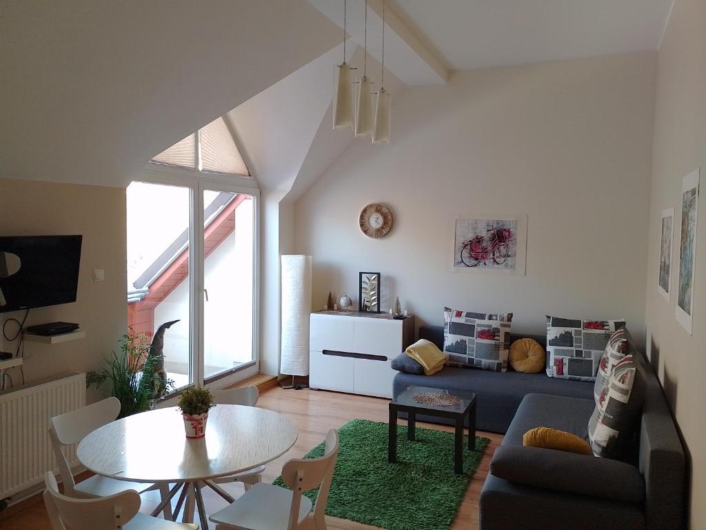 a living room with a couch and a table at Apartament Alias in Wisła