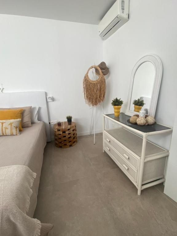 a bedroom with a bed and a mirror and a dresser at Casa Lorenzo in Puerto del Carmen