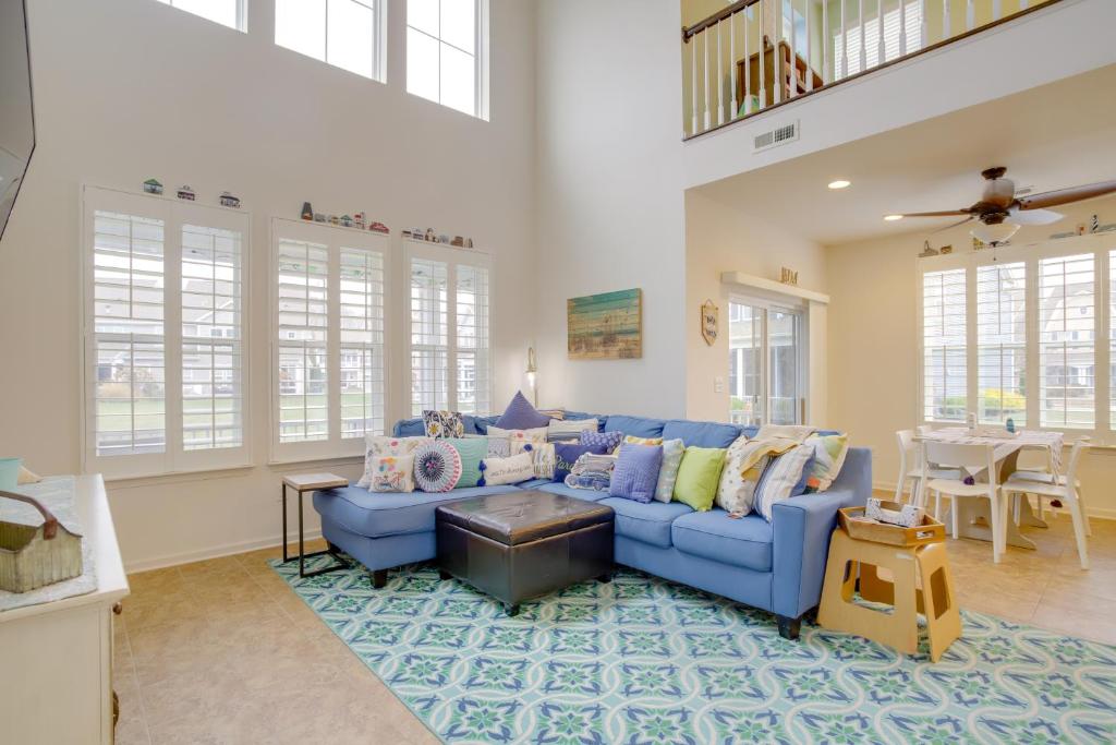 a living room with a blue couch and a table at Shuttle to Beach Millville Townhome with Porch in Millville