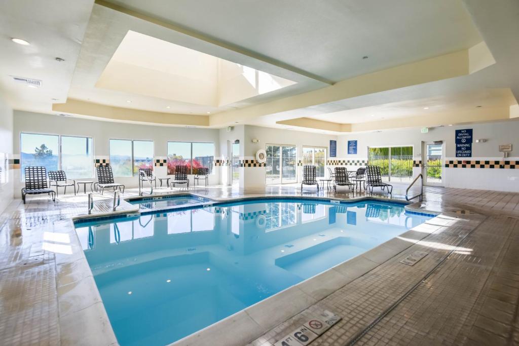 a large swimming pool with blue water in a building at Shutters Hotel in Elko