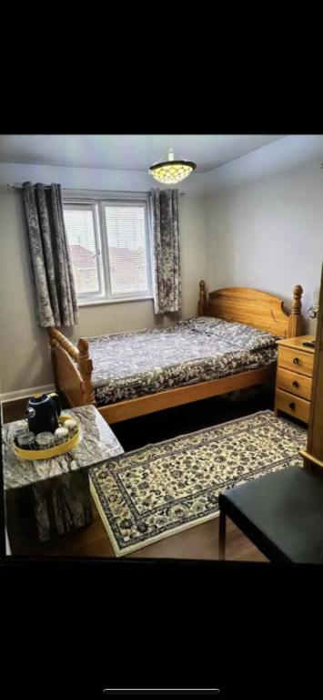 a bedroom with a large bed and a window at Deluxe Double Bed With Private Mordern Shower & Smart TV in Clydebank