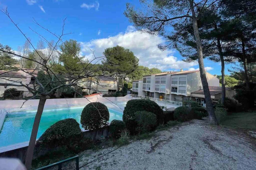 a house with a swimming pool in a yard at Agréable Studio Sanary-sur-mer in Sanary-sur-Mer