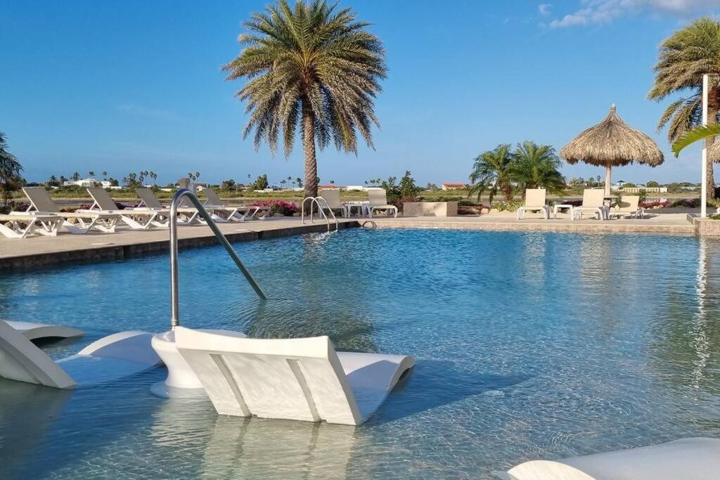 The swimming pool at or close to 3 minutes from best beaches in Aruba! Luxury Tropical Townhouse at Gold Coast Aruba