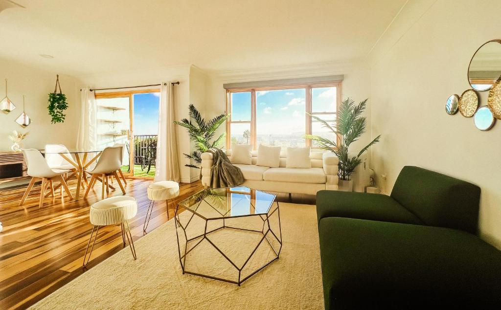 a living room with a couch and a table at Sunkissed Boho Hilltop Haven Apartment in San Diego