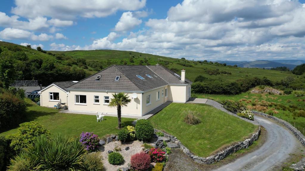 an aerial view of a white house in a field at Connemara Haven Bed and Breakfast in Oughterard