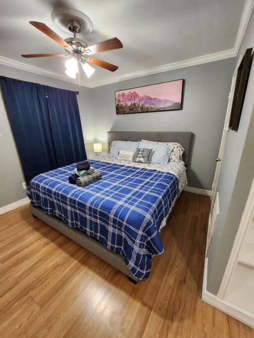 a bedroom with a bed with a ceiling fan at Blue Shark *E10* @ Midtown Vibrant King Studio in Houston