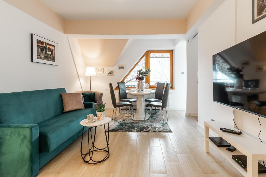 Televízia a/alebo spoločenská miestnosť v ubytovaní Apartamenty Orkana Centrum Zakopane