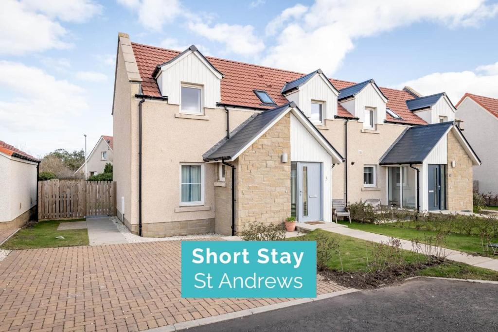 a row of houses with a sign that says short stay st audys at Pitmilly Park - 3 Beds - Garden in Kingsbarns