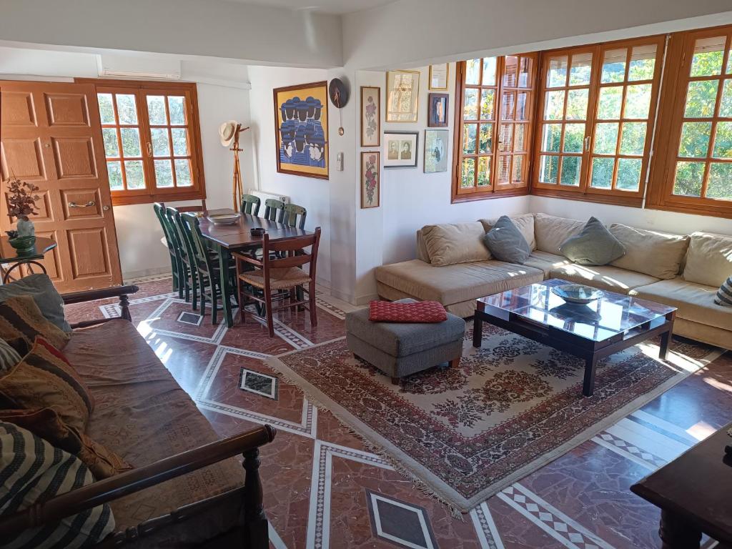 a living room with a couch and a table at Villa Masou Taygetos in Artemisía