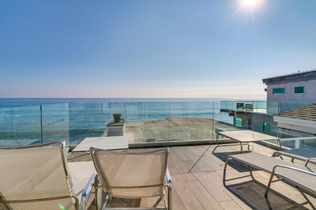 a balcony with chairs and a view of the ocean at Beachfront Malibu Apartment with Ocean-View Balcony in Malibu