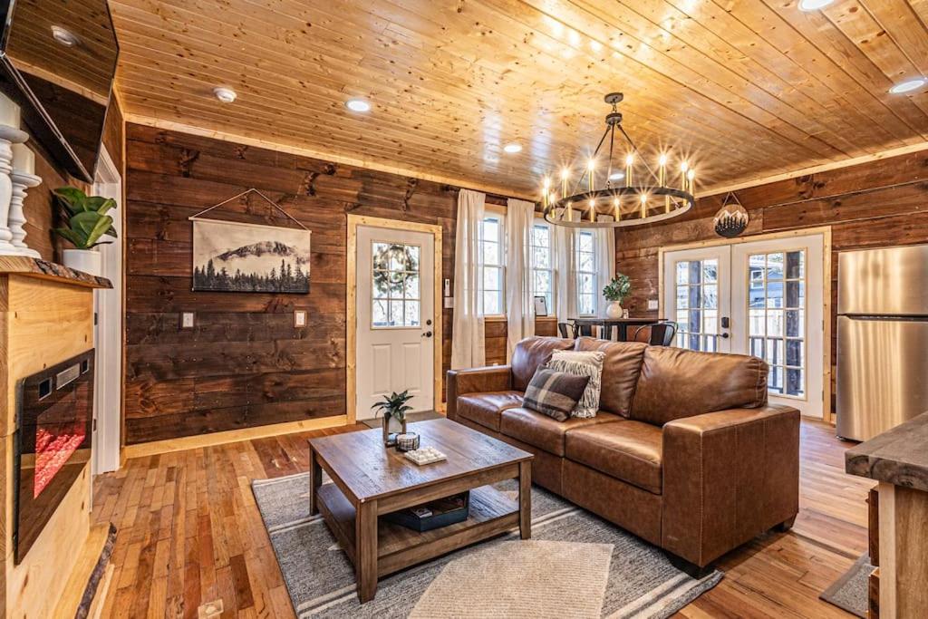 a living room with a couch and a table at Little Blue in the Smoky Mountains in Bryson City