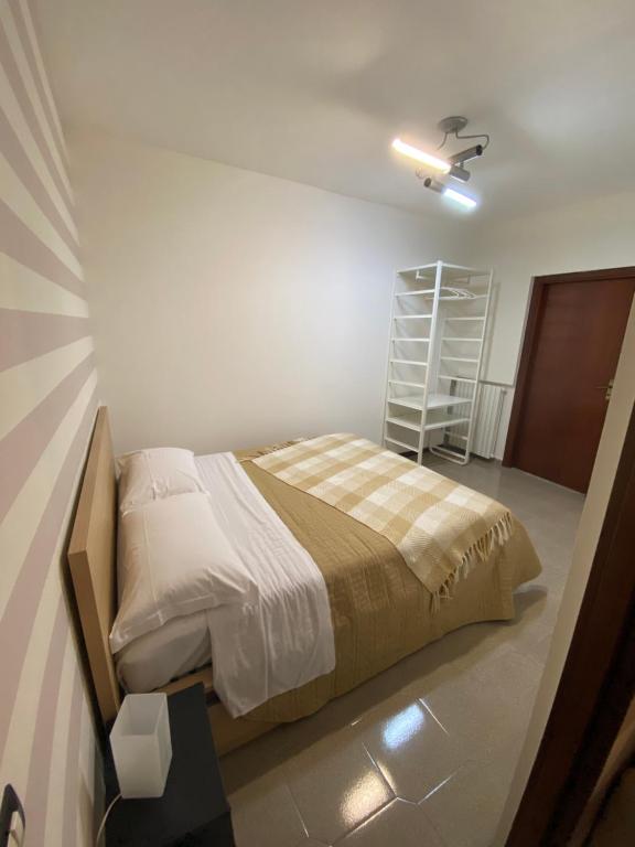 een slaapkamer met een bed en een plank bij LULU' LESUITES in Cava deʼ Tirreni