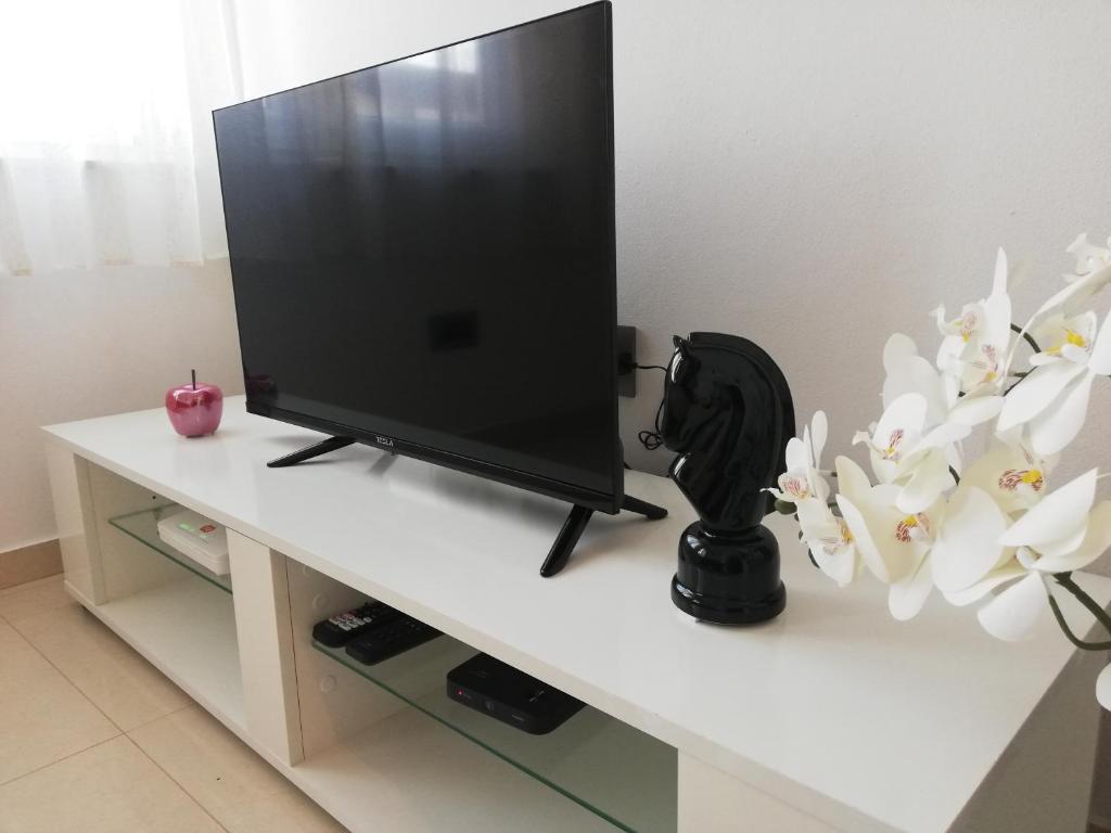a flat screen tv sitting on a white table at Apartma Mi-Mari2 in Koper