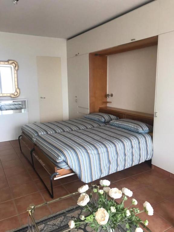 a bedroom with a large bed with a mirror on the wall at Bellevue- Bellavista in Castagnola