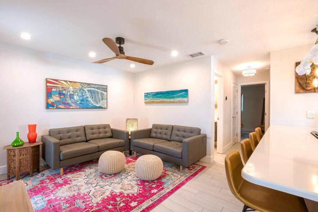 a living room with two couches and a table at TOP RATED! Namaste Here steps to Flagler & Beach in New Smyrna Beach