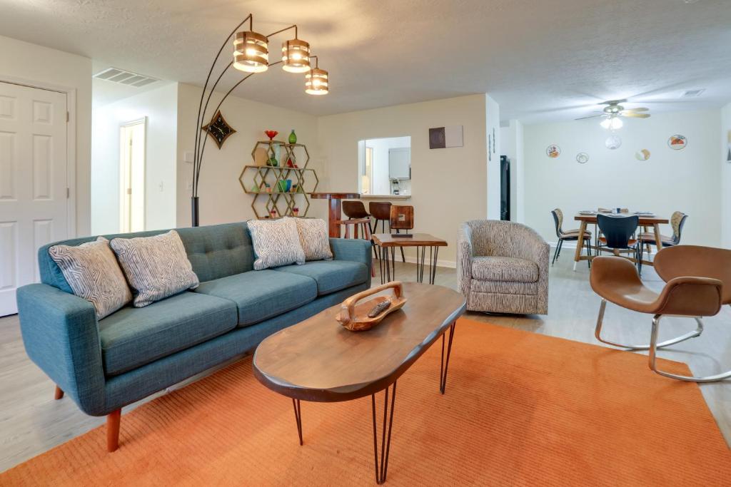 a living room with a blue couch and a table at Chic Lexington Home with Deck about 5 Mi to Downtown! in Lexington