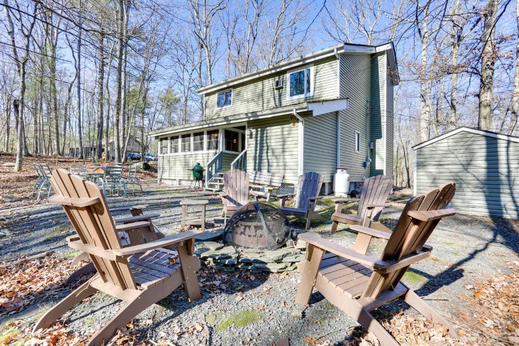a group of chairs sitting in front of a house at Rustic Masthope Mountain Retreat with Private Sauna! in Hawley