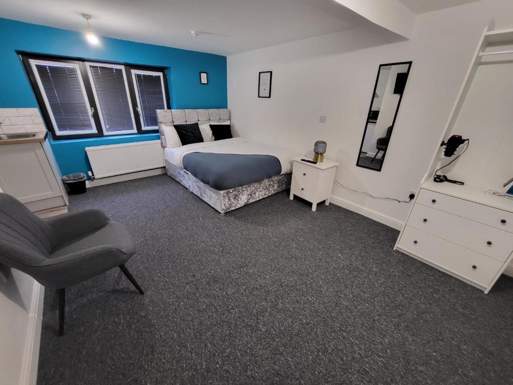a bedroom with a bed and a dresser and a chair at Stay Sleep Rest - Tring Vale in Nottingham