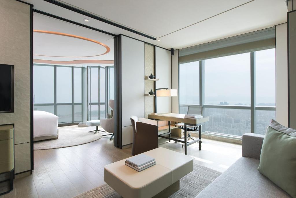 a living room with a couch and a table at Shenzhen Marriott Hotel Nanshan in Shenzhen