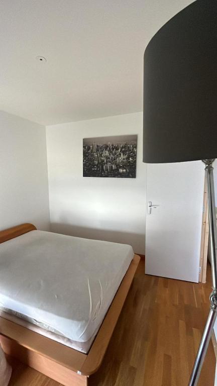 1 dormitorio con 1 cama y 1 lámpara en Appartement à Cholet, à 25min du Puy du Fou, en Cholet