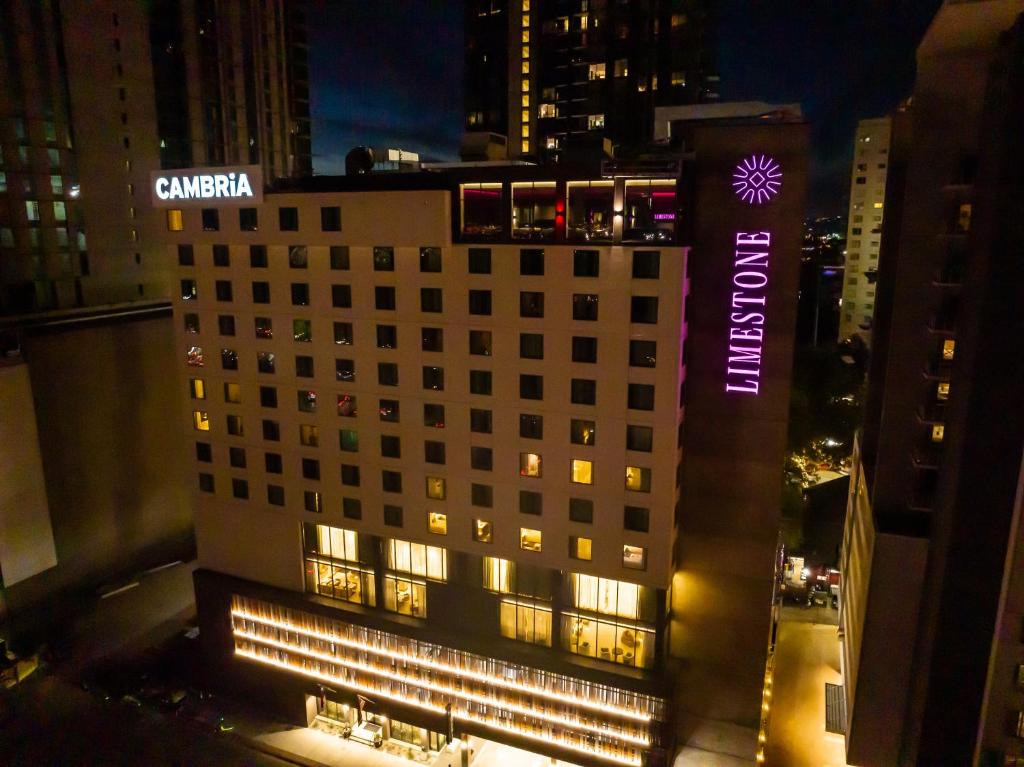 a building with a sign on the side of it at night at Cambria Hotel Austin Downtown in Austin