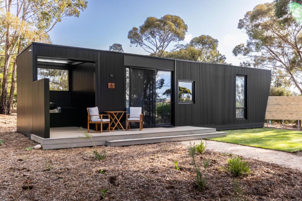 a black shipping container house on a yard at CABN X Seppeltsfield Barossa in Seppeltsfield