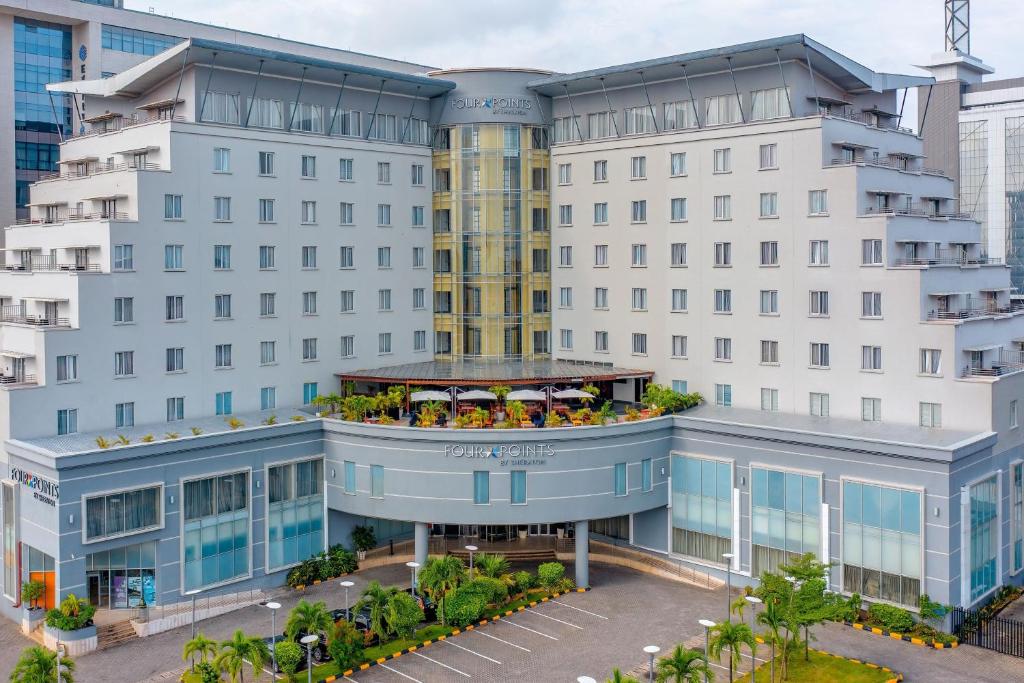 an apartment building with a balcony with people on it at Four Points by Sheraton Lagos in Lagos