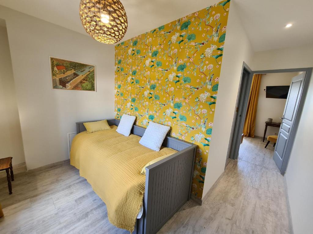 a bedroom with a bed with a yellow bedspread at Guestroom Briare, 1 pièce, 2 personnes - FR-1-590-369 in Briare