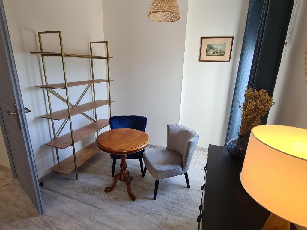 a room with a table and two chairs and a shelf at Guestroom Briare, 1 pièce, 2 personnes - FR-1-590-369 in Briare