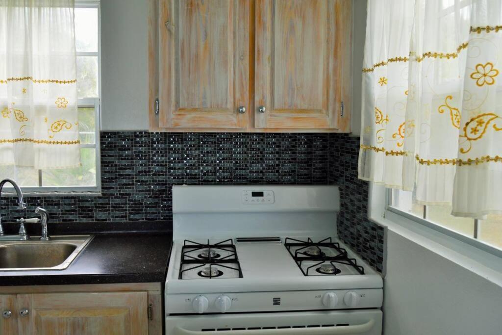 una cucina con piano cottura bianco e lavandino di Pearl's Hilltop Cottage 