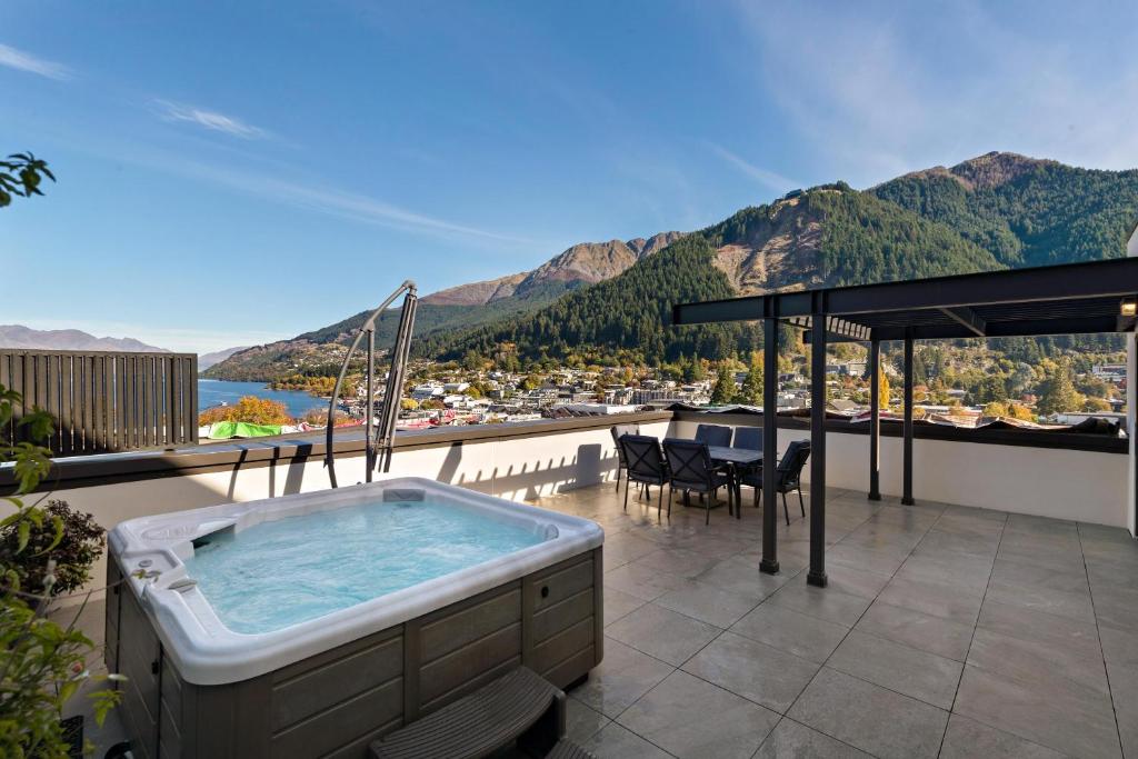 a hot tub on the balcony of a house at The Glebe Apartments in Queenstown