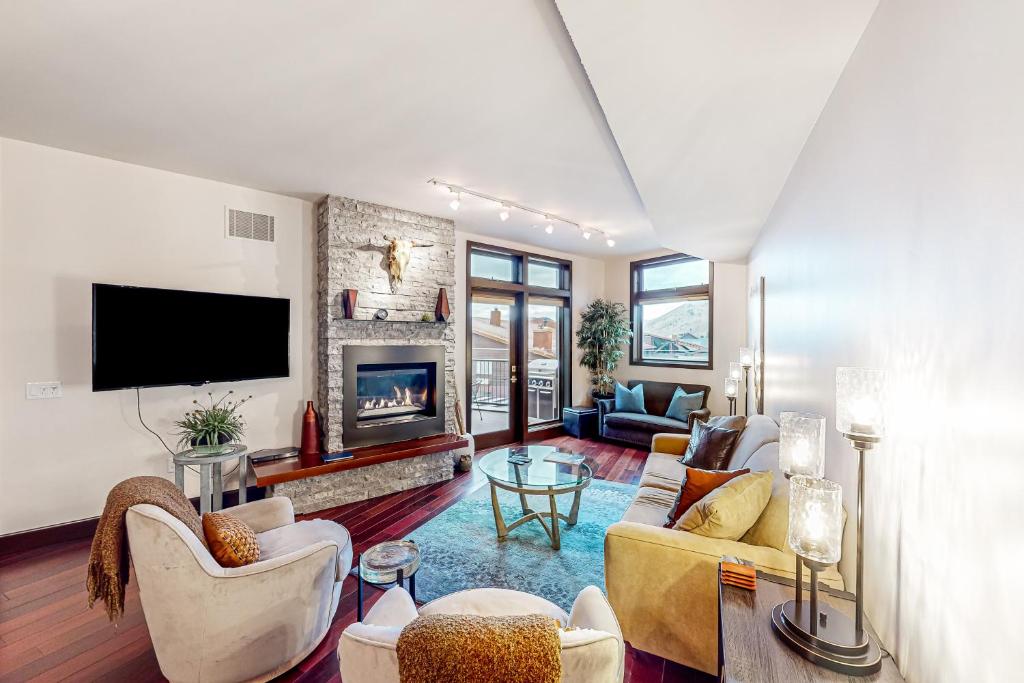 a living room with a couch and a fireplace at Pearl At Jackson #203 in Jackson