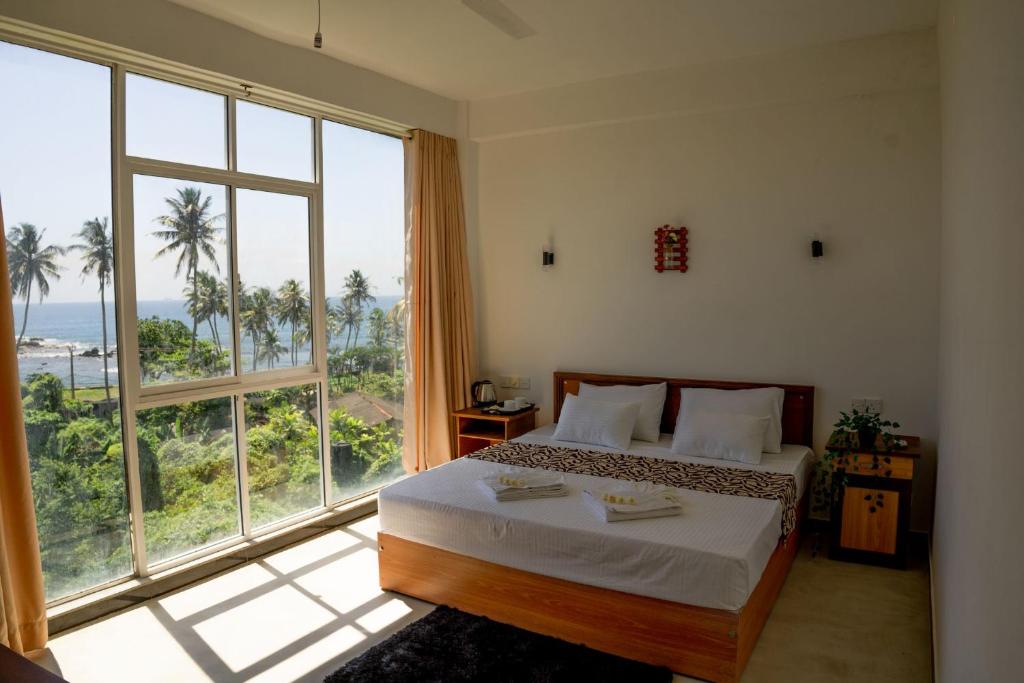 Кровать или кровати в номере Tevins Place - Unawatuna