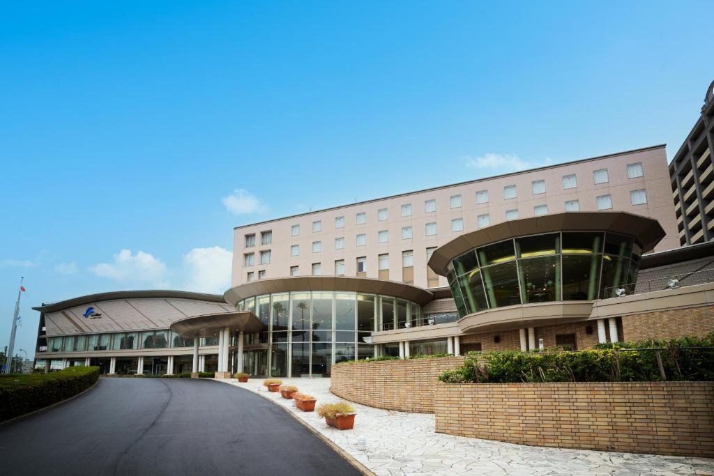 a large building with a road in front of it at Hotel Welview Kagoshima in Kagoshima