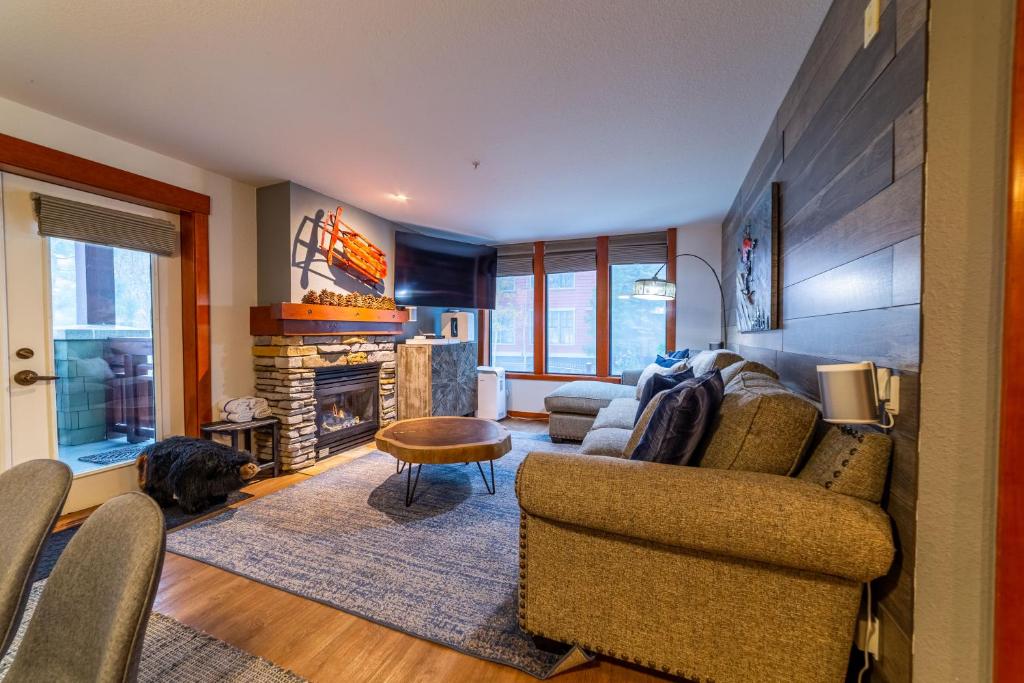 a living room with a couch and a fireplace at Luxurious Remodeled Village Oasis in Mammoth Lakes