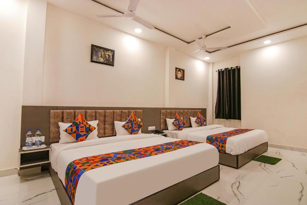a hotel room with two beds in a room at FabHotel Aryan Grand in Amritsar