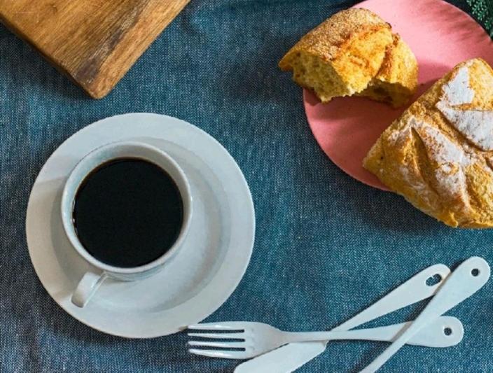 a plate with a cup of coffee and a piece of bread at Tatev in Garni