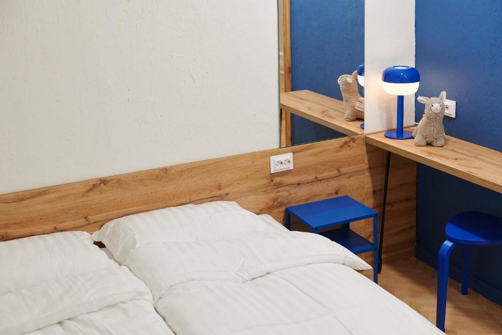 Postel nebo postele na pokoji v ubytování Lama Hostel