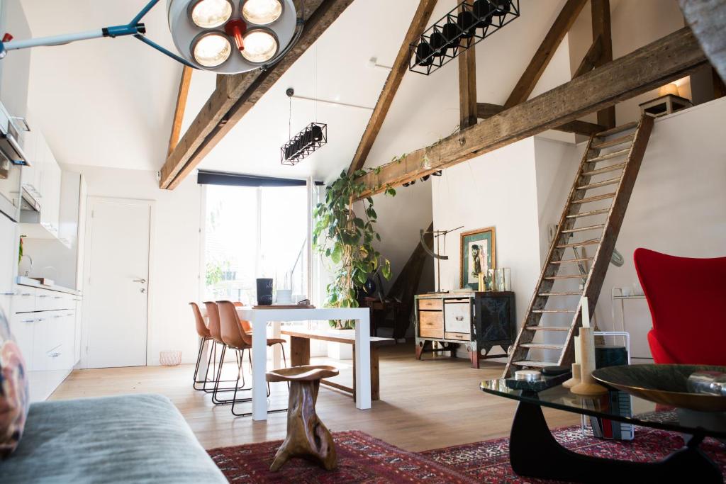 a living room and dining room with a loft at Tempor'area Apartment in Antwerp