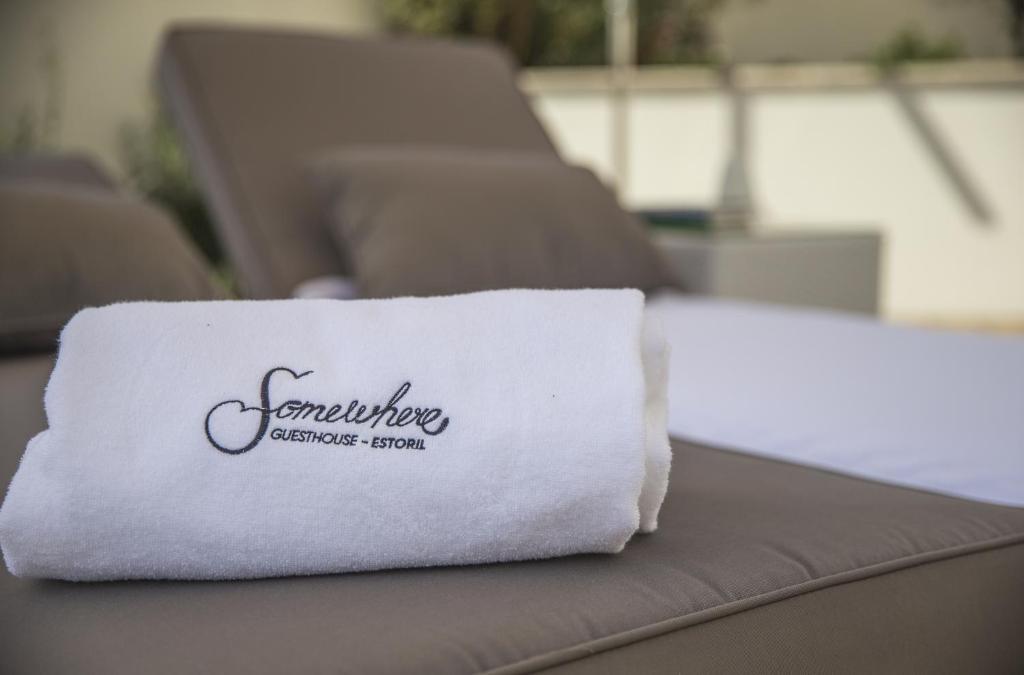 a white towel sitting on top of a couch at Somewhere - Estoril Guesthouse in Estoril