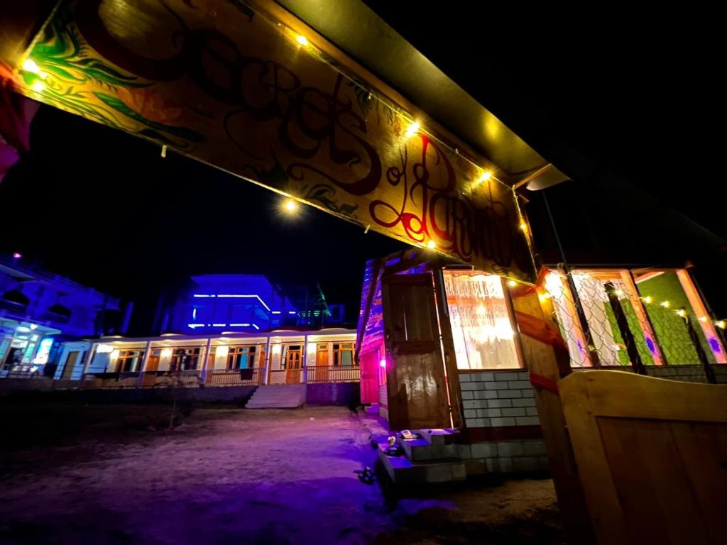 a building with lights on the side of it at night at Secrets of Parvati in Kalgha