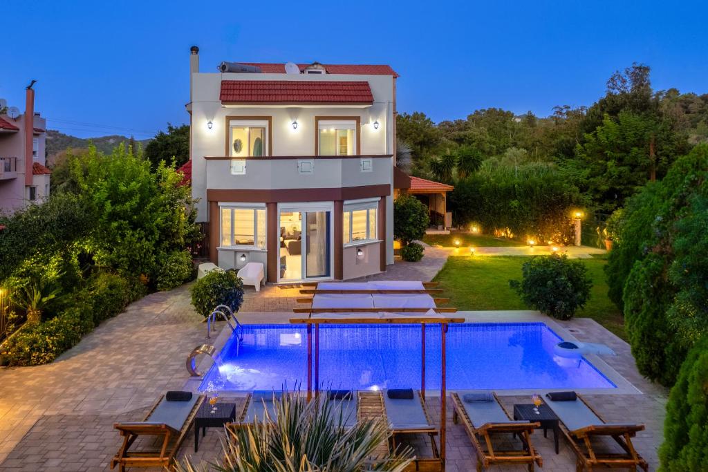 a house with a swimming pool in the backyard at EvMar Villa in Rhodes Town