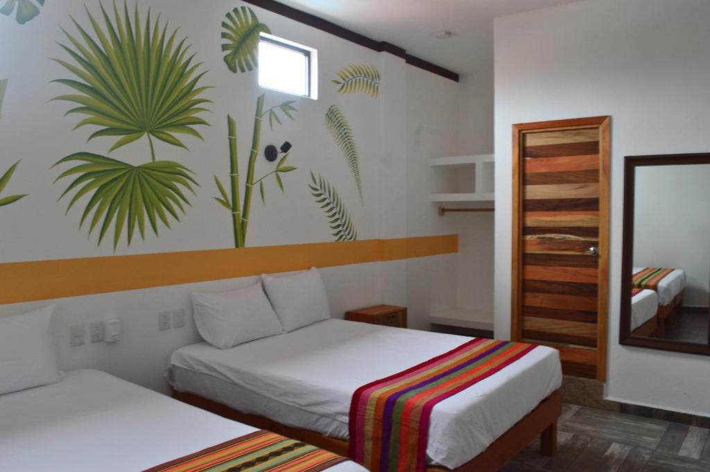 Postel nebo postele na pokoji v ubytování Hotel Axolotl